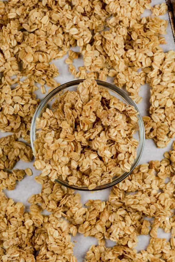 gluten free nut free granola on a baking tray and in a small glass bowl