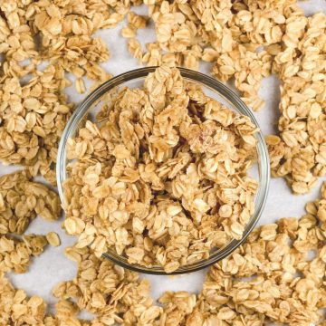 gluten free nut free granola in a glass bowl on parchment paper