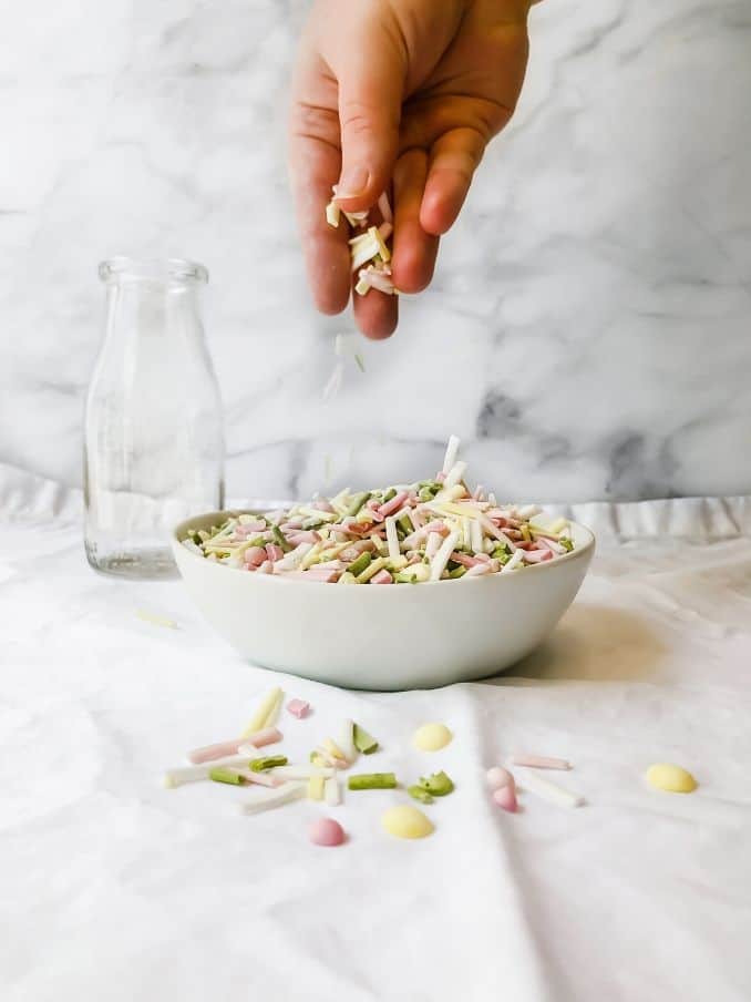 homemade vegan sprinkles being dropped from a hand into a bowl // livingbeyondallergies.com