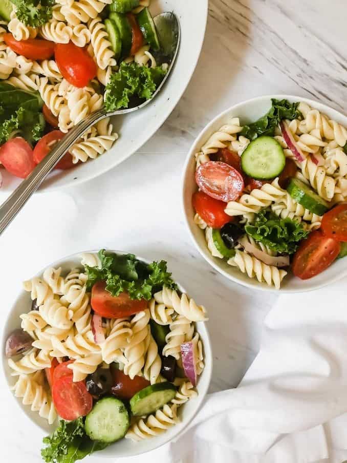 easy lemon pasta salad in small bowls ready for serving on a white table // livingbeyondallergies.com