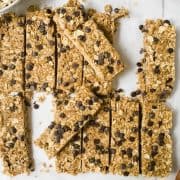 nut free granola bars on a white parchment paper with chocolate chips // livingbeyondallergies.com