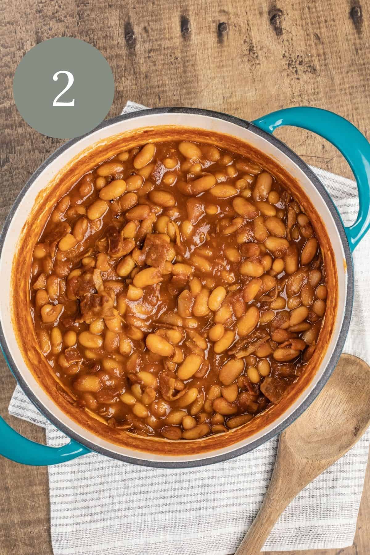 overhead view of baked beans in a blue cooking pot after cooking