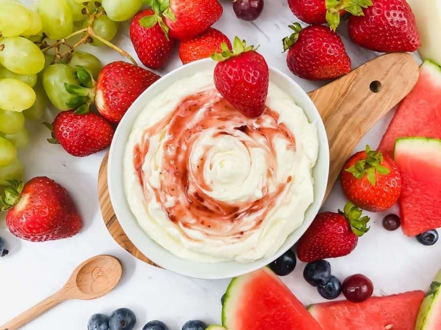 close up of 3 ingredient fruit dip surrounded by fruit on a white marble top // livingbeyondallergies.com