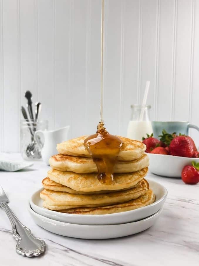 stack of gluten free and vegan pancakes on a plate on a white table // livingbeyondallergies.com