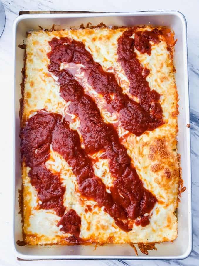 detroit style pizza after baking on a white countertop