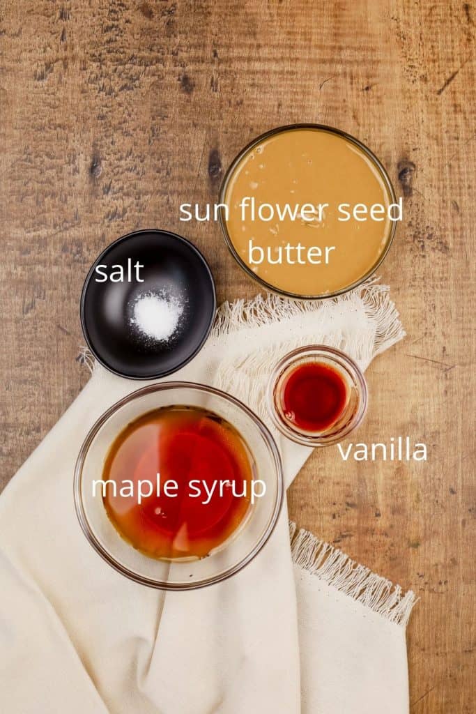 ingredients for caramel sauce  in small glass bowls on a wood table