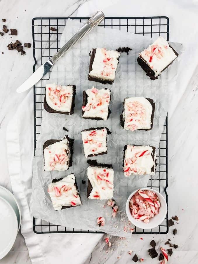 peppermint brownies on a cooling rack with a knife and peppermint sprinkles on the countertop // livingbeyondallergies.com