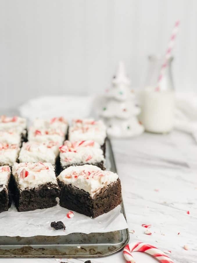peppermint brownies on a baking tray with crumbs on a white countertop