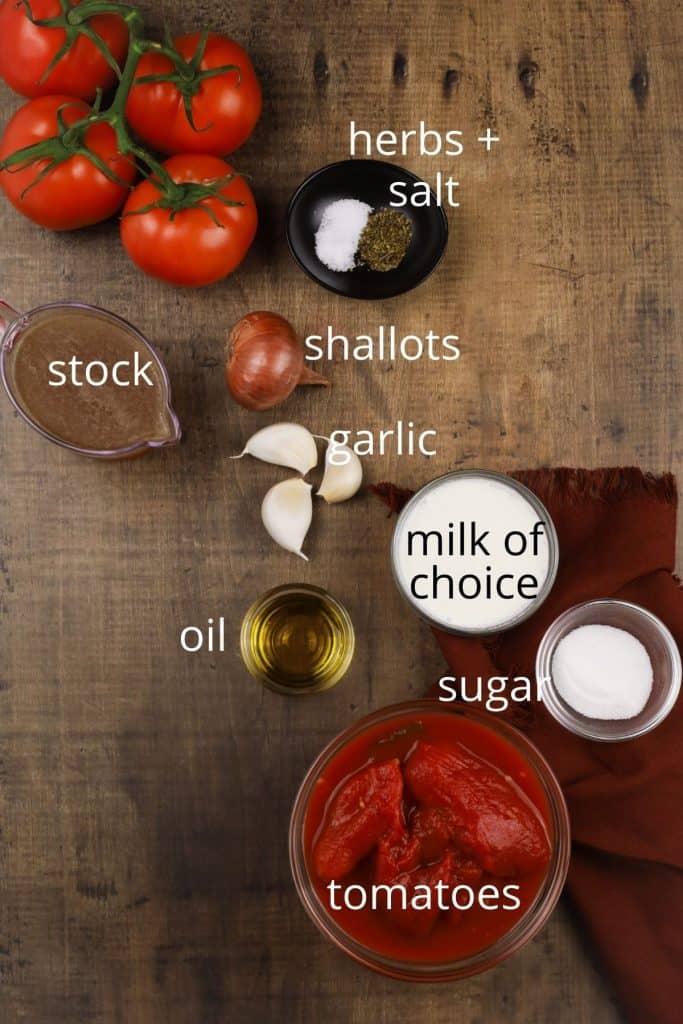 overhead view of ingredients for tomato soup in various bowls