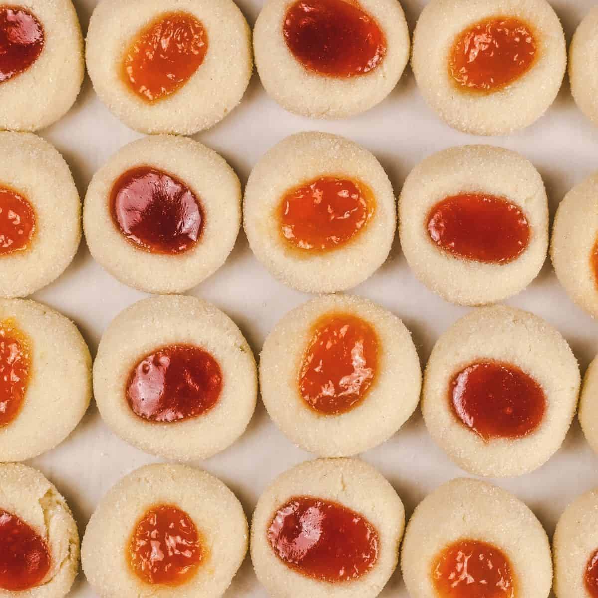 overhead view of many gluten free thumbprint jam cookies close together