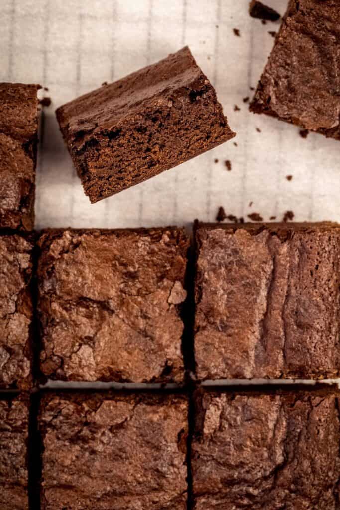 egg free brownies cut into giant squares on white parchment paper