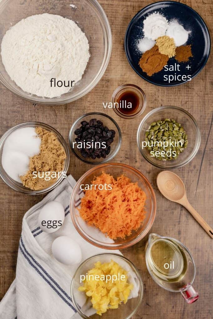 ingredients for carrot cake in various bowls on the table 