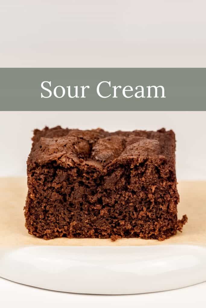 a sour cream brownie on a white plate