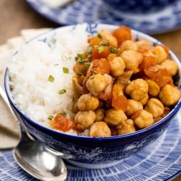 close up of Chana Masala in a blue bowl with rice