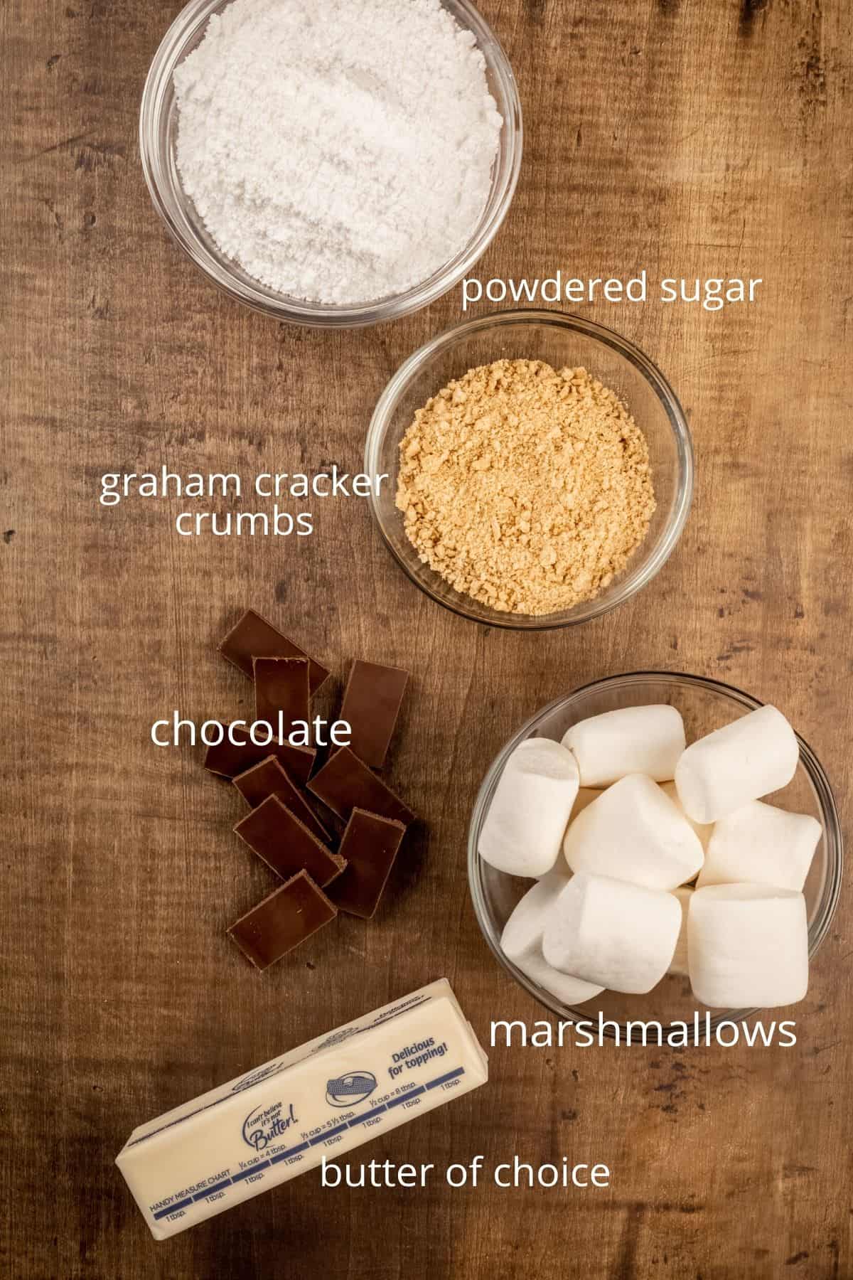 ingredients for marshmallow frosting in various glass bowls on the table