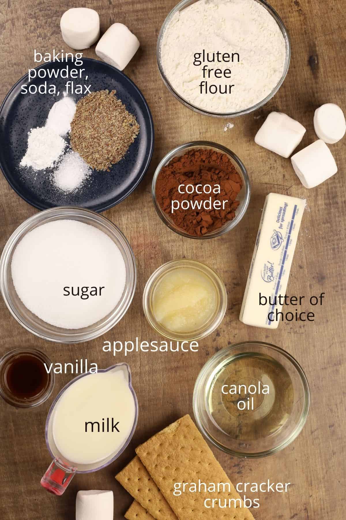 ingredients for s'mores cupcakes in various glass bowls on the kitchen table