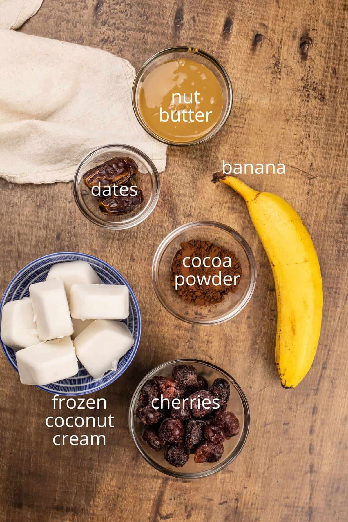ingredients for dairy free weight gain shakes in various glass bowls on the wood kitchen table.