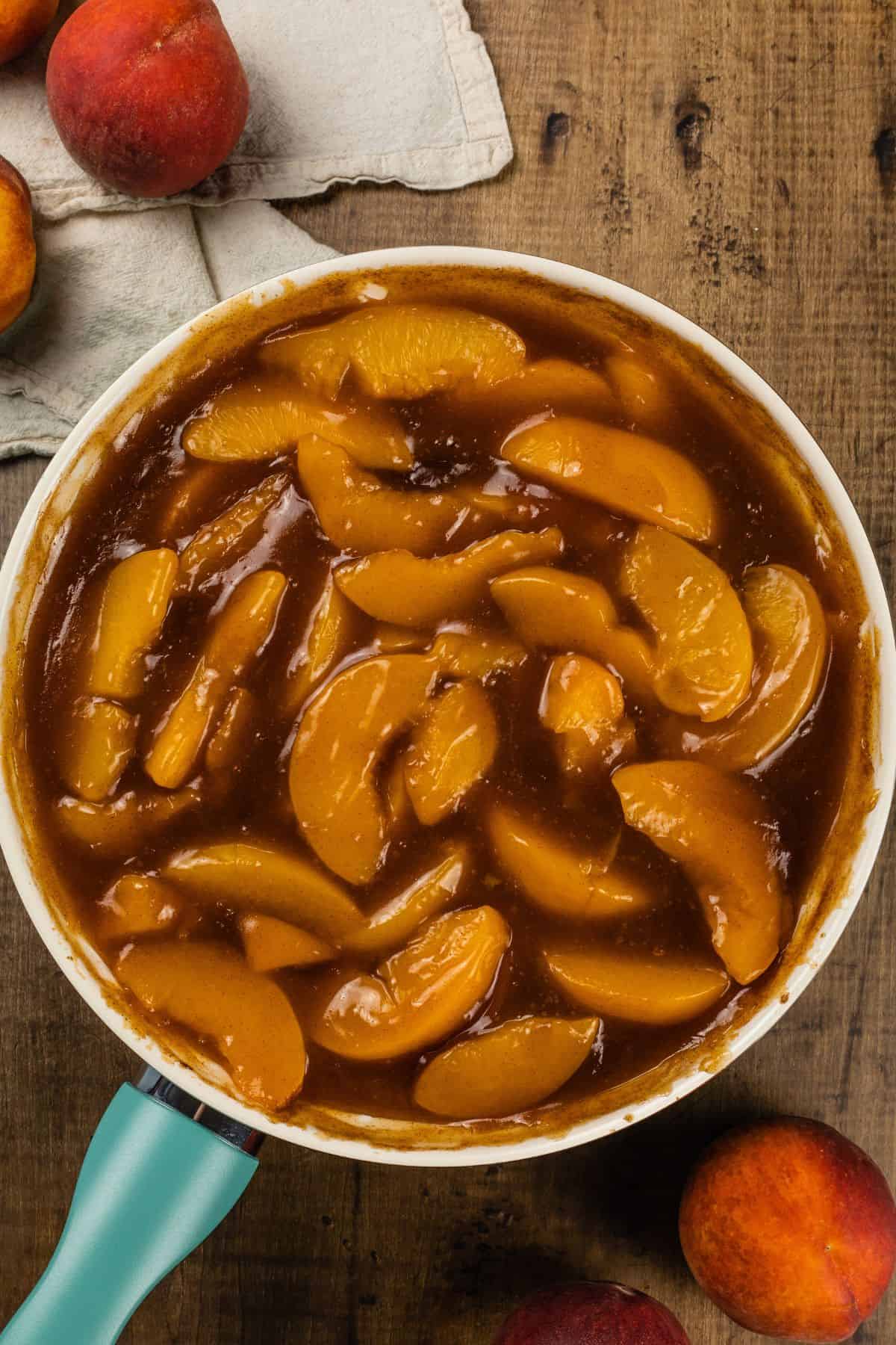 peach pie filling in a fry pan after cooking down