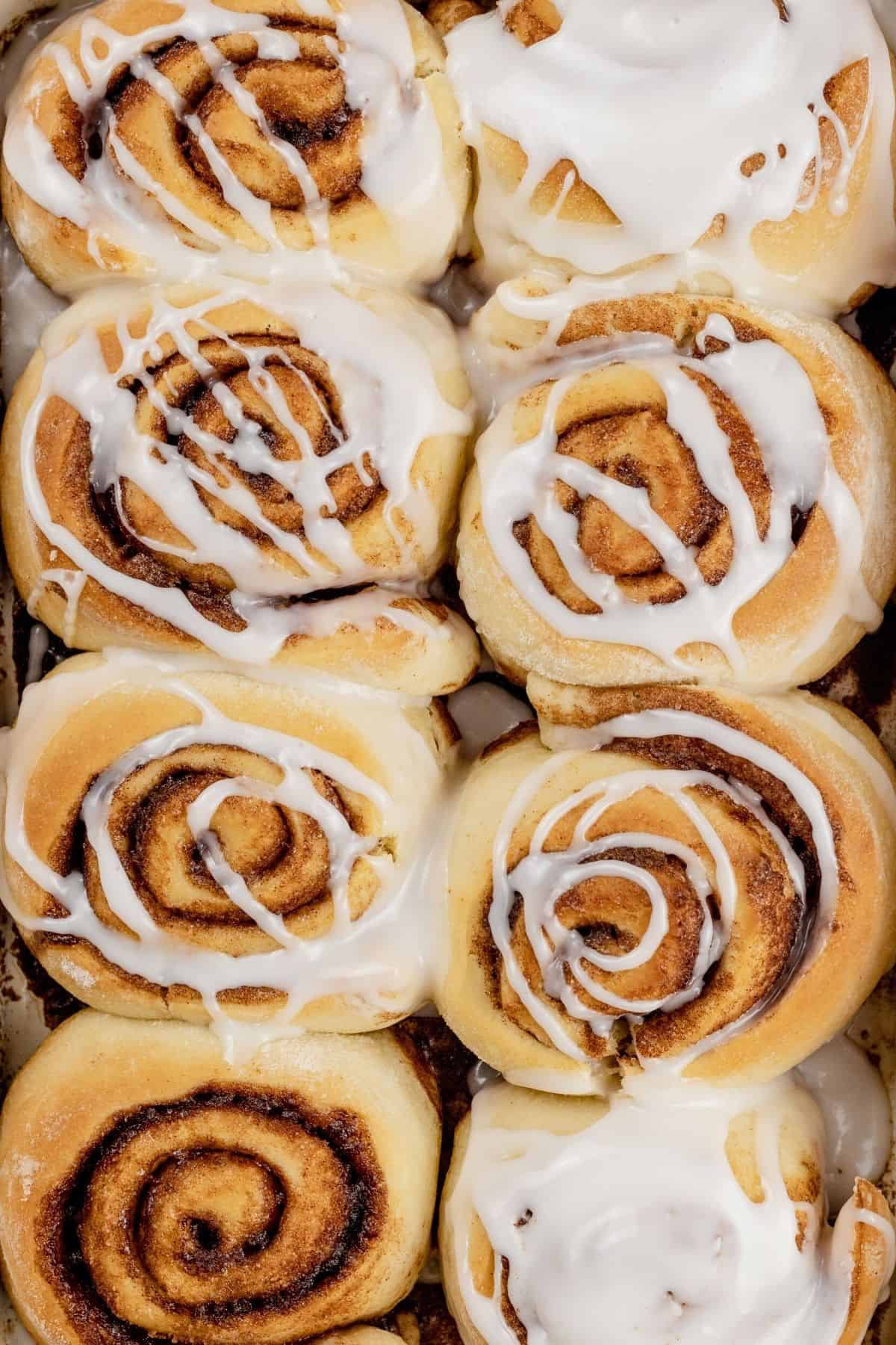 overview of 8 baked and iced cinnamon rolls.