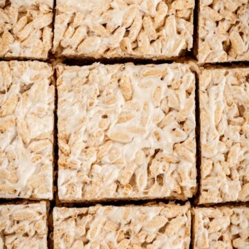 Close up on 9 gluten free Rice Krispie treats slices in a pan.