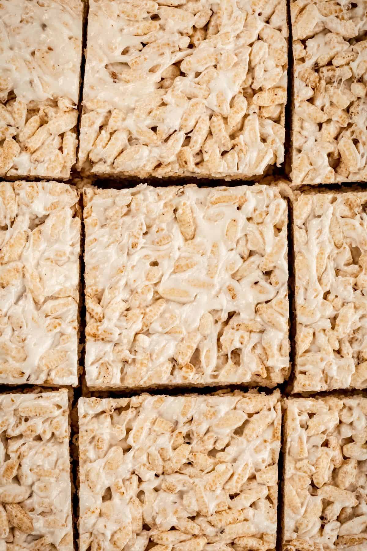Close up of 9 gluten free Rice Krispie treats in slices in a pan.