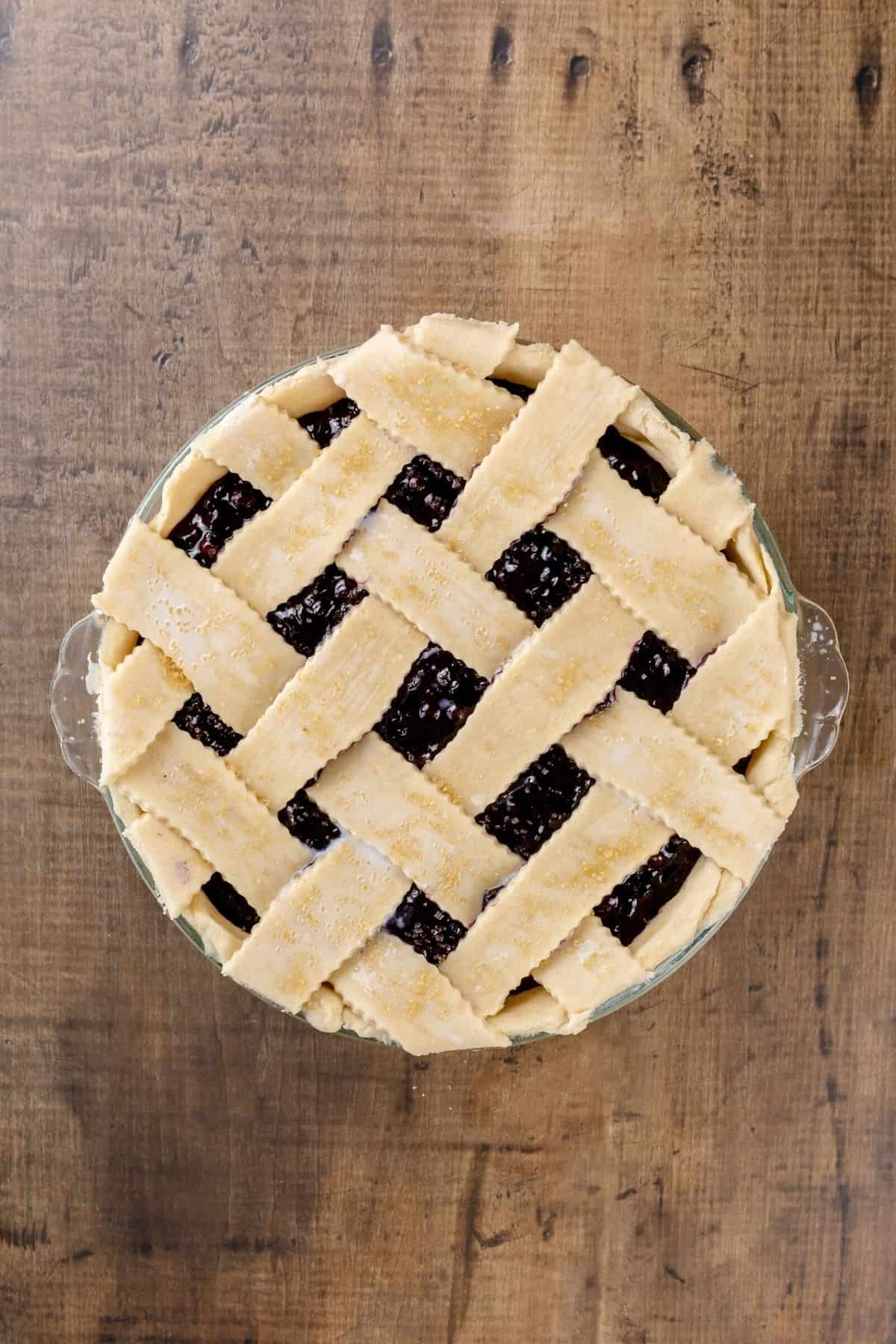 Showing the lattice work on top of a blueberry pie before baking.