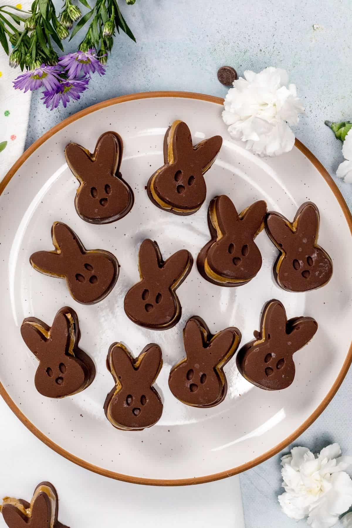 A close up of many sun butter bunny candies on a plate.